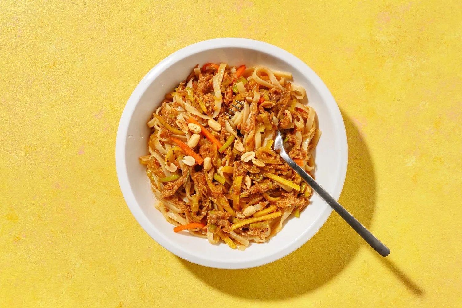 Express noodles with pulled pork, winter vegetables, and peanuts