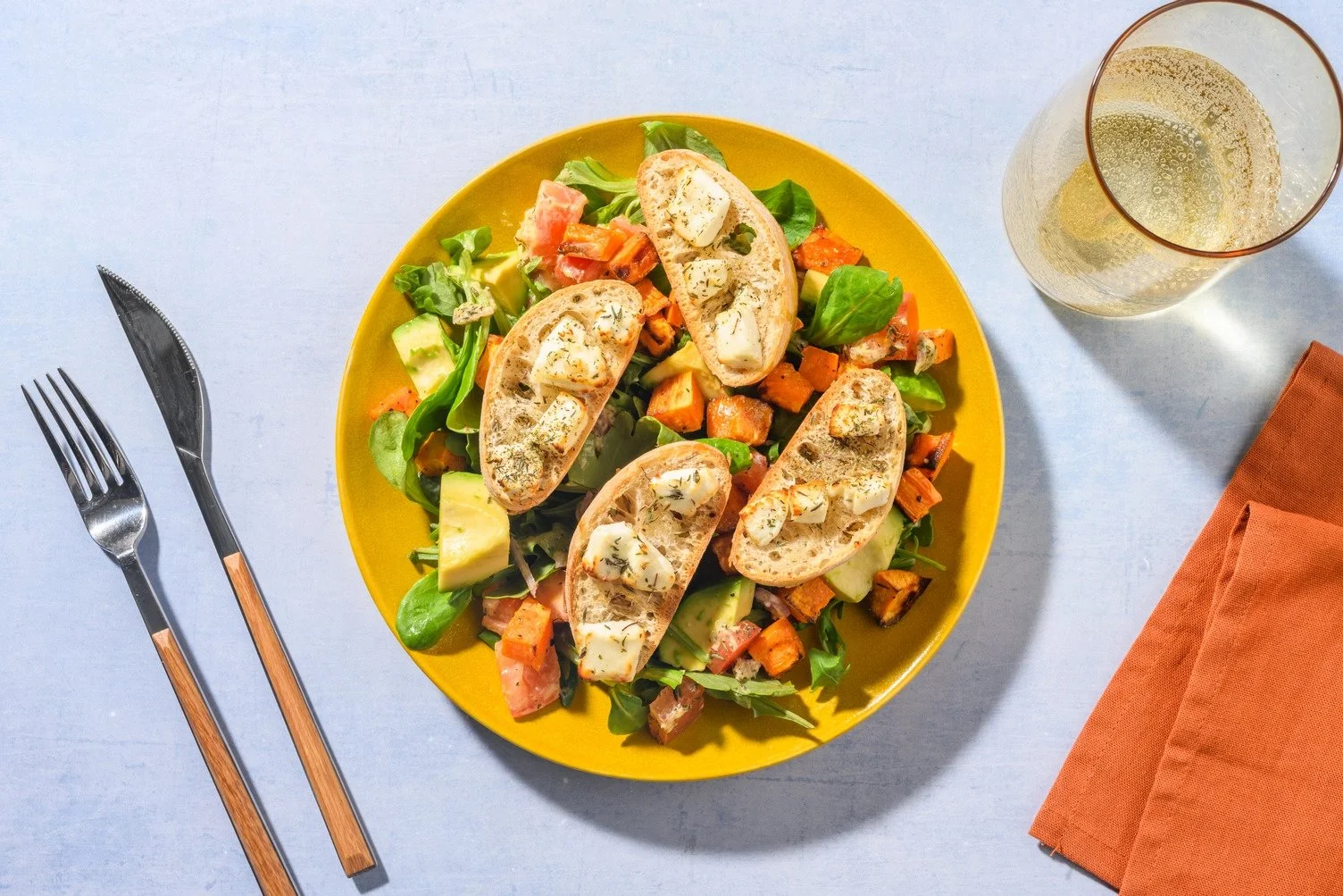 Salad of avocado and goat cheese toast with honey
